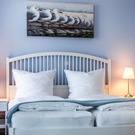 Appartement Gloria - Gemütliches Schlafzimmer mit Meeresthema und Kissen